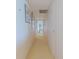 Hallway with neutral carpet and fresh paint, leading to various rooms in the home at 31 Island Way # 907, Clearwater Beach, FL 33767