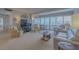 Living room area with sweeping waterfront views and neutral decor in condo at 31 Island Way # 907, Clearwater Beach, FL 33767
