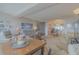 Bright and airy living room with serene decor, adjoining dining area, and water views at 31 Island Way # 907, Clearwater Beach, FL 33767