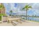 Waterfront lounging area with shower and multiple chairs offers a relaxing outdoor oasis at 31 Island Way # 907, Clearwater Beach, FL 33767