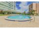 Enjoy the community pool with inviting pool and ample seating, water views and building backdrop at 31 Island Way # 907, Clearwater Beach, FL 33767