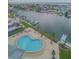 Aerial view of the waterfront pool, deck, and community boat docks at 31 Island Way # 907, Clearwater Beach, FL 33767