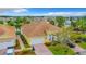 Overhead view showcasing a home with a brick driveway, tile roof, landscaped grounds, and a two-car garage at 4737 Casswell Dr, New Port Richey, FL 34652