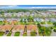 Aerial view of a waterfront community showcasing homes with red tile roofs and canal access at 4737 Casswell Dr, New Port Richey, FL 34652