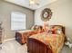 Cozy bedroom with two beds, decorative pillows, a large mirror, and ample natural light at 4737 Casswell Dr, New Port Richey, FL 34652