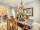 Elegant dining room showcasing a large table, chandelier, and decorative painting at 4737 Casswell Dr, New Port Richey, FL 34652