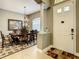 Welcoming dining room adjacent to front entry featuring large window and chandelier at 4737 Casswell Dr, New Port Richey, FL 34652