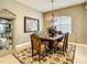 Formal dining room with a chandelier, decorative rug, and ornate wooden table at 4737 Casswell Dr, New Port Richey, FL 34652