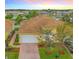 Charming yellow home with a tile roof, brick driveway, and attached two car garage at 4737 Casswell Dr, New Port Richey, FL 34652