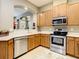 Bright kitchen features stainless steel appliances, light wood cabinets, and an arched opening at 4737 Casswell Dr, New Port Richey, FL 34652