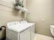 Functional laundry area with a washer and dryer set, wire shelving, and clean, minimalist design elements at 4737 Casswell Dr, New Port Richey, FL 34652