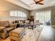 Comfortable living room featuring neutral tones, recessed ceiling, and large sliding glass door at 4737 Casswell Dr, New Port Richey, FL 34652
