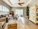 Well-lit living room shows neutral color scheme, recessed ceiling, and sliding glass doors at 4737 Casswell Dr, New Port Richey, FL 34652