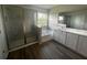Modern bathroom featuring a glass-enclosed shower, soaking tub, and double vanity with marble countertop at 708 160Th E Ln, Bradenton, FL 34212