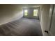 Spacious carpeted bedroom with two windows offering natural light at 708 160Th E Ln, Bradenton, FL 34212