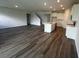Open concept living room features hardwood floor and a kitchen island with white cabinets at 708 160Th E Ln, Bradenton, FL 34212
