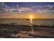 Peaceful beach sunset view with boat on water at 4737 Casswell Dr, New Port Richey, FL 34652
