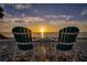 Two chairs and a table facing the ocean at sunset at 4737 Casswell Dr, New Port Richey, FL 34652