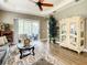 Living room with hardwood floors, a decorative cabinet, and comfy seating at 4737 Casswell Dr, New Port Richey, FL 34652