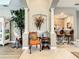 Living room with orange accent chair, decorative accents, and view of kitchen at 4737 Casswell Dr, New Port Richey, FL 34652