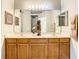 Double vanity bathroom with wood cabinets and neutral countertops at 4737 Casswell Dr, New Port Richey, FL 34652