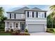 Modern two-story house with gray siding, stone accents, and landscaping at 708 160Th E Ln, Bradenton, FL 34212