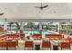 Community pool area with orange couches and a ceiling fan at 708 160Th E Ln, Bradenton, FL 34212