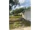 Home's backyard with grassy area and side yard at 12501 Holyoke Ave, Tampa, FL 33624