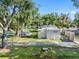 Exterior view of a mobile home with a yard and boat cover at 12501 Holyoke Ave, Tampa, FL 33624