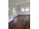 Bright living room with dark wood floors and large windows at 12501 Holyoke Ave, Tampa, FL 33624