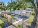 Aerial view of a mobile home with a fenced yard and surrounding trees at 12501 Holyoke Ave, Tampa, FL 33624