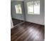 Bright bedroom with mirrored closet and wood-look flooring at 12501 Holyoke Ave, Tampa, FL 33624