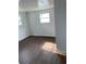 Spacious bedroom with wood-look floors and bright natural light at 12501 Holyoke Ave, Tampa, FL 33624
