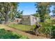 Exterior view of a mobile home with a yard and chain link fence at 12501 Holyoke Ave, Tampa, FL 33624