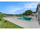 Community pool with lounge chairs and a view of the lake at 3822 Cortez Dr # D, Tampa, FL 33614