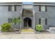 Gray condo building with entrance and landscaping at 3822 Cortez Dr # D, Tampa, FL 33614
