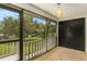 Screened porch with wood-look tile flooring and access to backyard at 3822 Cortez Dr # D, Tampa, FL 33614