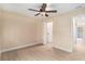 Well-lit bedroom with ceiling fan and access to bathroom at 3822 Cortez Dr # D, Tampa, FL 33614
