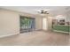 Living room with light wood floors, ceiling fan and view of kitchen at 3822 Cortez Dr # D, Tampa, FL 33614