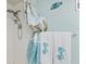 Bathroom with a shower with a decorated curtain and matching mermaid towels on the towel rack at 4550 Cove Cir # 501, St Petersburg, FL 33708