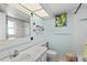 Bathroom with a mirror, sink, toilet, and tiled shower/tub at 4550 Cove Cir # 501, St Petersburg, FL 33708