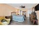 Bedroom features a large bed, wood floors, and furnishings at 4550 Cove Cir # 501, St Petersburg, FL 33708