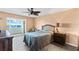Cozy bedroom with a large bed, wood floors, and a slider door to a balcony with a water view at 4550 Cove Cir # 501, St Petersburg, FL 33708