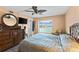 Well-lit bedroom with a large bed, wood floors, and a slider door to a balcony with a water view at 4550 Cove Cir # 501, St Petersburg, FL 33708