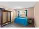 Charming bedroom featuring a daybed, light walls, and a distinctive wooden armoire for storage at 4550 Cove Cir # 501, St Petersburg, FL 33708