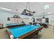 Spacious billiard room featuring multiple pool tables and ample lighting for enjoyable gameplay at 4550 Cove Cir # 501, St Petersburg, FL 33708
