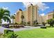 Attractive multi-story condo building featuring multiple balconies, manicured landscaping, and convenient covered parking at 4550 Cove Cir # 501, St Petersburg, FL 33708