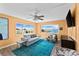 Sun-filled living room with a TV, area rug, and water views from the large windows at 4550 Cove Cir # 501, St Petersburg, FL 33708