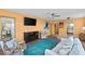 Comfortable living room with a blue area rug, bright furniture, and a TV at 4550 Cove Cir # 501, St Petersburg, FL 33708