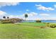 Community putting green and outdoor lounge area with views of sailboats on the water at 4550 Cove Cir # 501, St Petersburg, FL 33708